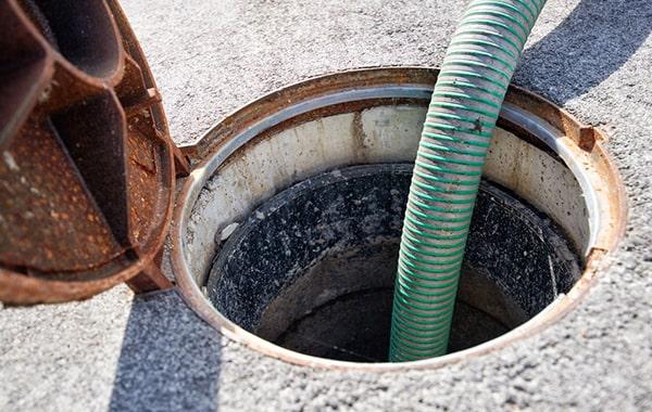 signs that a grease trap needs pumping include foul odors, slow drainage, and visible grease build-up